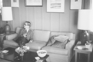 Photograph of James Davis, UCLA librarian and friend of the poet, seated in the living room of the poet’s house on Miramar Beach in Montecito, California.