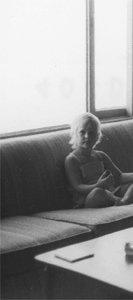 Photograph of unidentified girl (Alison Trimpi?) seated in the living room of the poet’s house on Miramar Beach in Montecito, California (July, 1972).