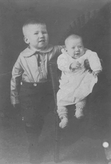 Photograph of Edgar Bowers at age two years, nine months, with his sister  Eleanor Bowers, age three months, in Selma, Alabama (Christmas, 1926).