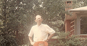 Photograph of Edgar Bowers standing behind his mother, Grace Bowers, in front of the Bowers's house near Stone Mountain, Georgia (July, 1967).